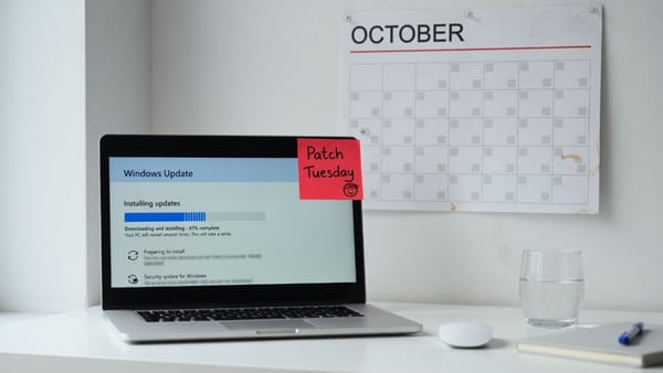 Laptop installing Windows updates in front of an October 2026 calendar with Patch Tuesday circled